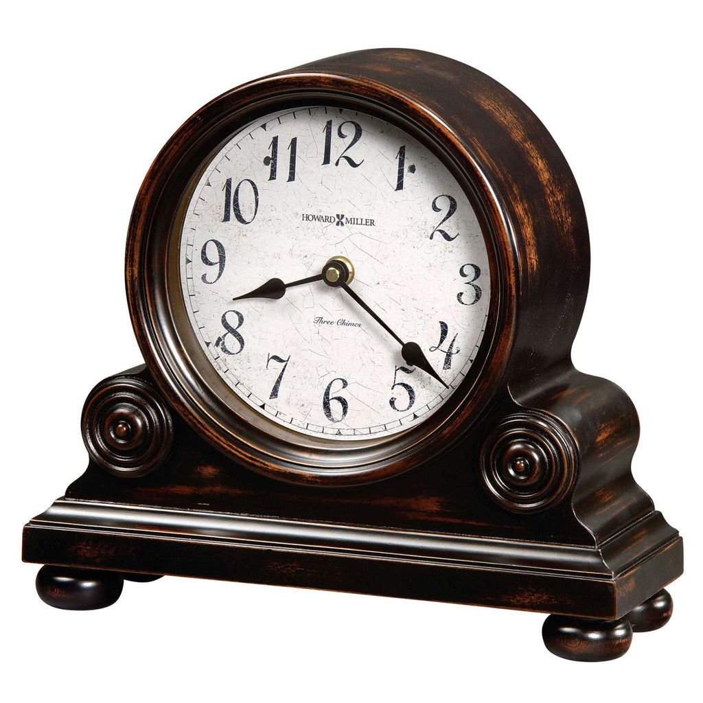 A vintage-style mantel clock with a round face and ornate wooden base.