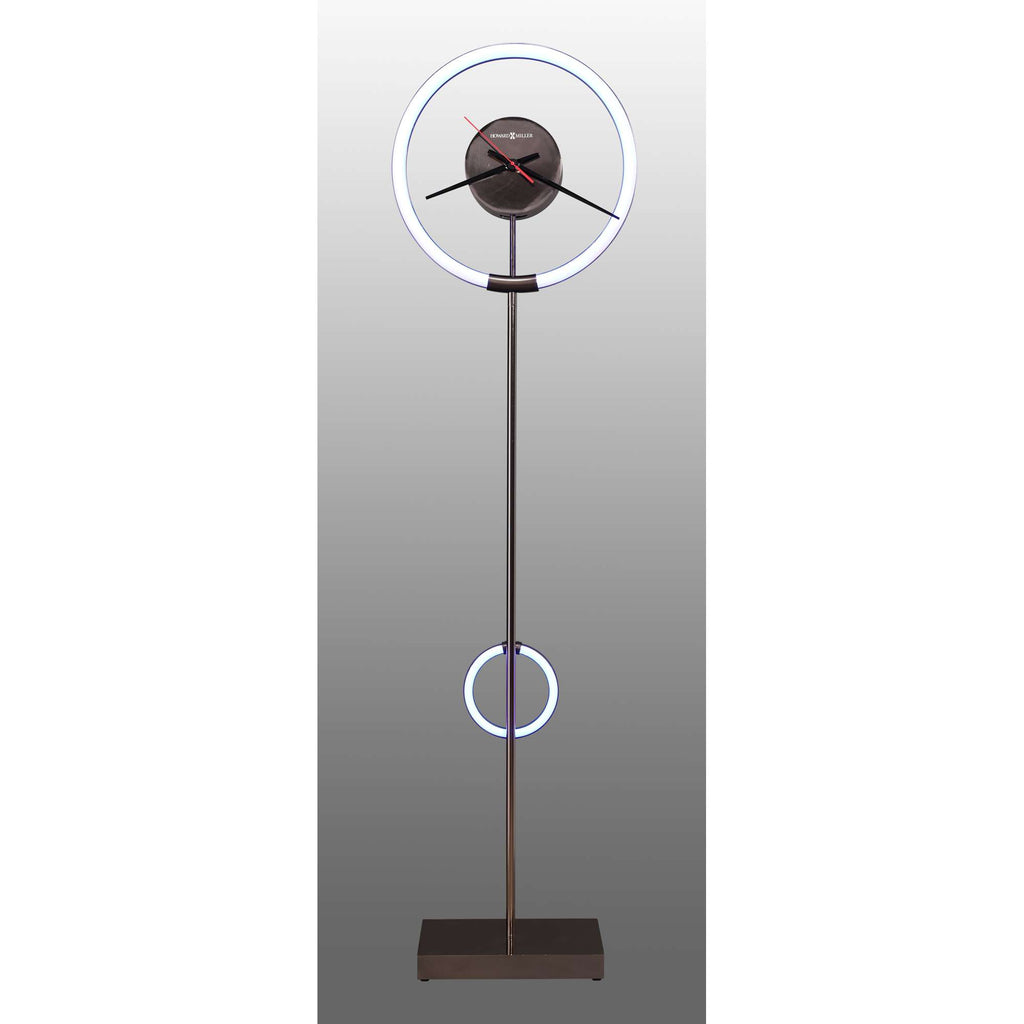 A modern floor clock with a circular design and illuminated rings.