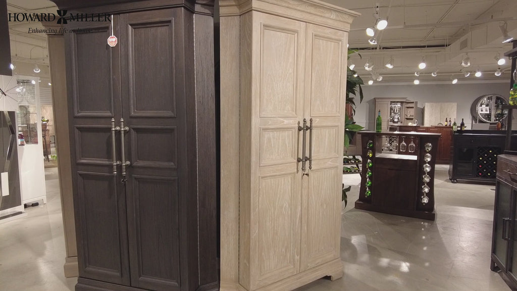 Two tall cabinets in a showroom, one dark and one light wood finish.
