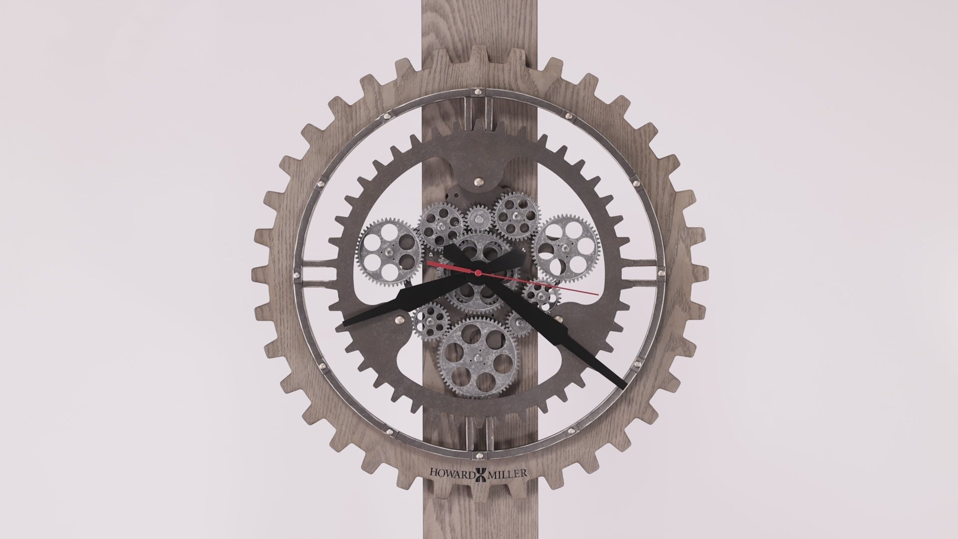 A stylish wall clock with a gear design and visible mechanisms.