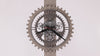 A stylish wall clock with a gear design and visible mechanisms.