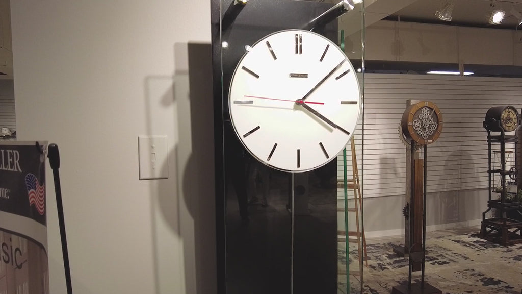 Modern wall clock displayed in an exhibition space.
