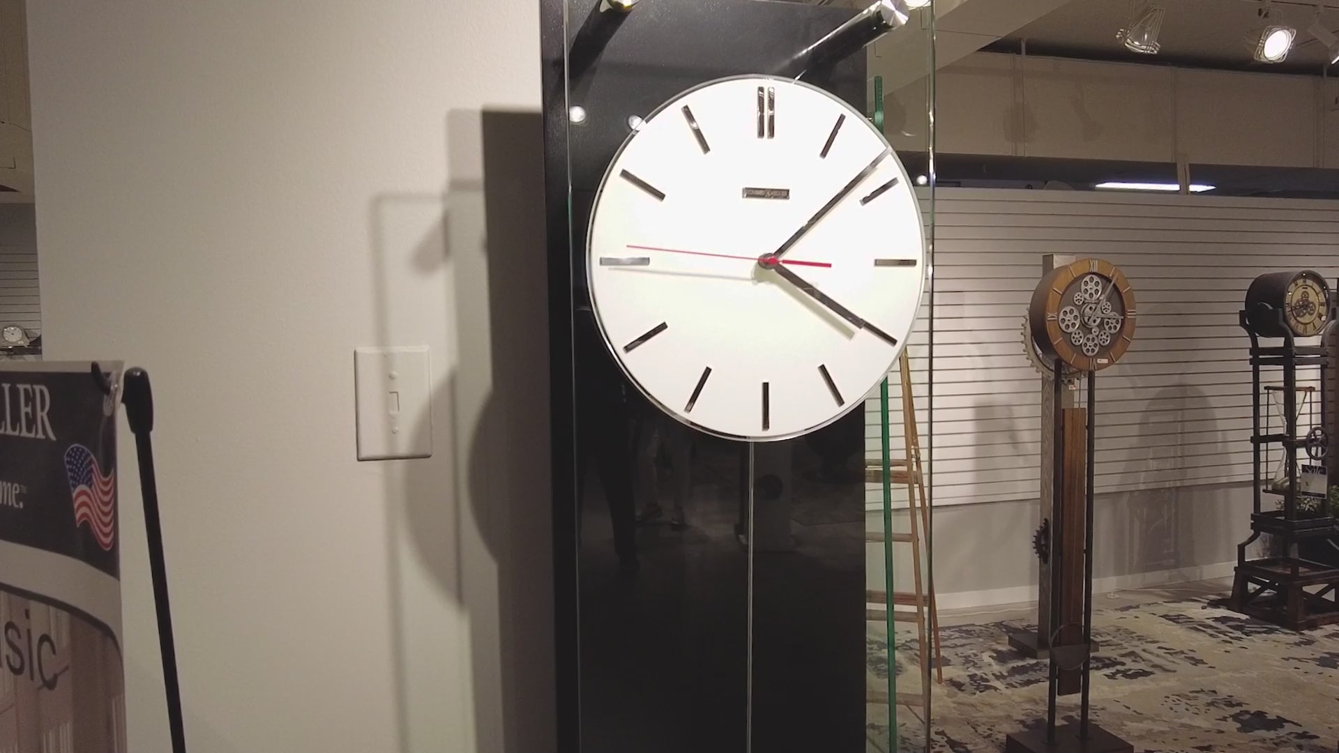 Modern wall clock displayed in an exhibition space.
