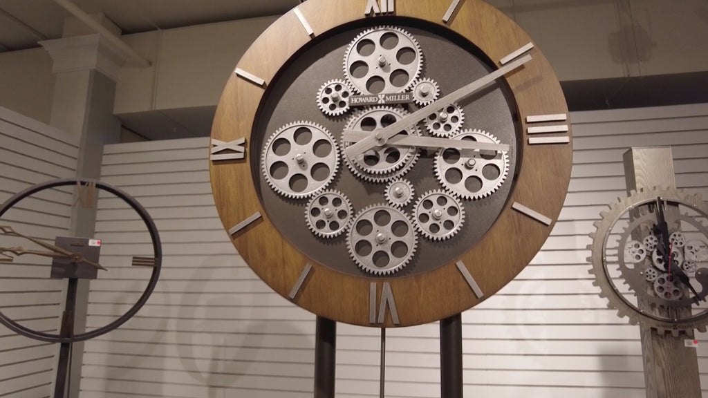 A large wall clock featuring a gear mechanism with wooden accents.