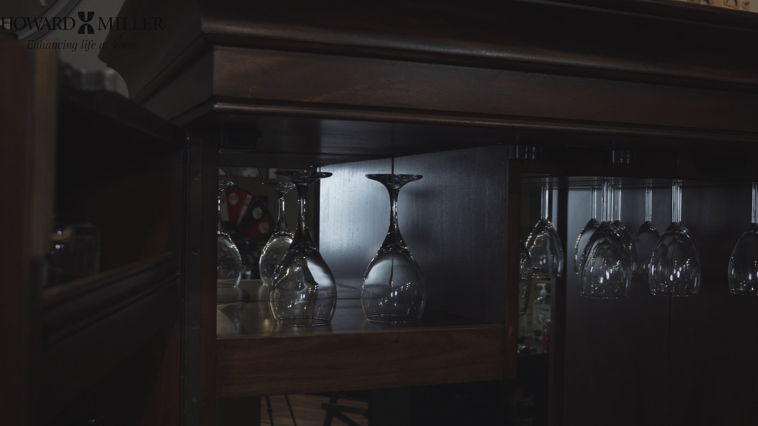 View of hanging wine glasses in a wooden cabinet