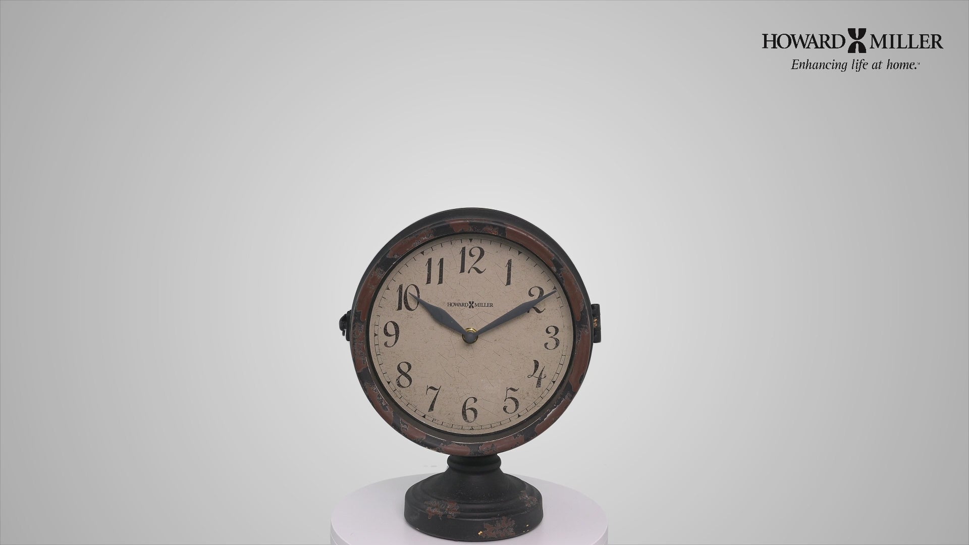 Vintage round clock with Roman numerals on a display stand