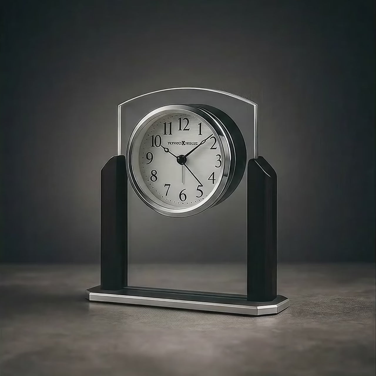A sleek, modern desk clock with a silver and black design.