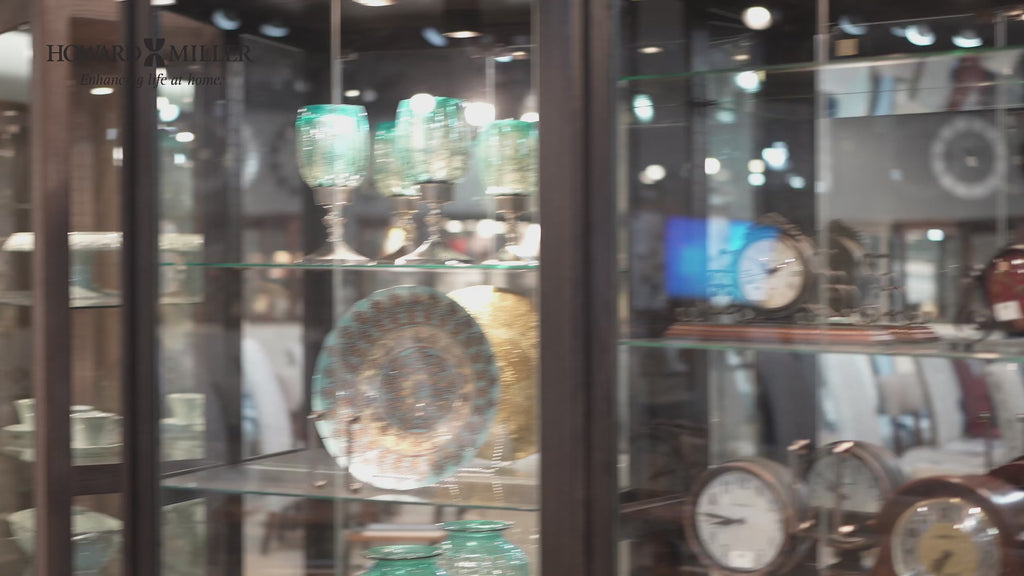 A display case filled with various decorative items including glassware and clocks.