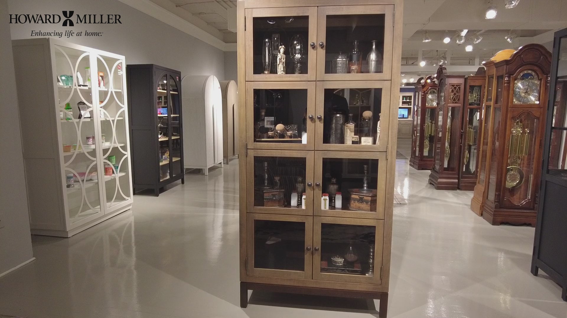Display cabinet showcasing various collectibles in a furniture showroom.