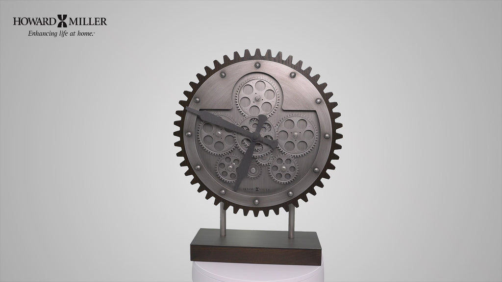 A decorative clock designed as a gear, featuring intricate details, mounted on a stand.