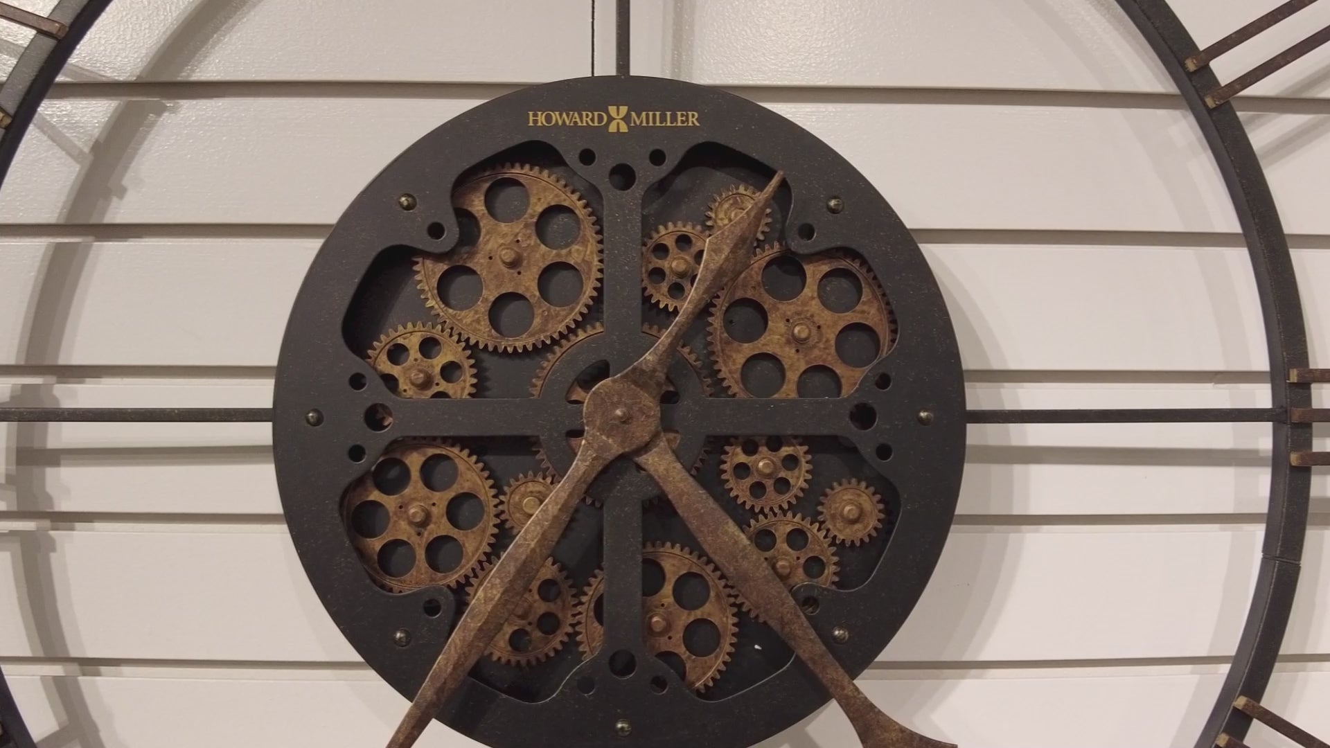 Close-up of a vintage-style wall clock with exposed gears