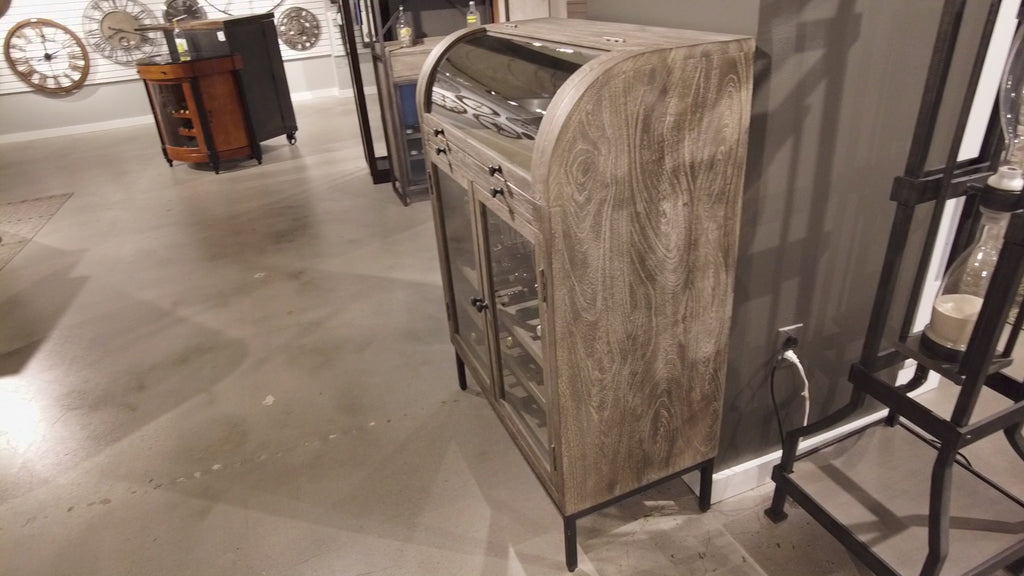 A modern wooden cabinet with a curved top, placed in a contemporary interior setting.