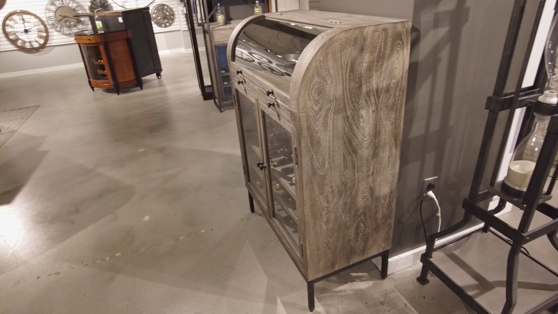 A modern wooden cabinet with a curved top, placed in a contemporary interior setting.