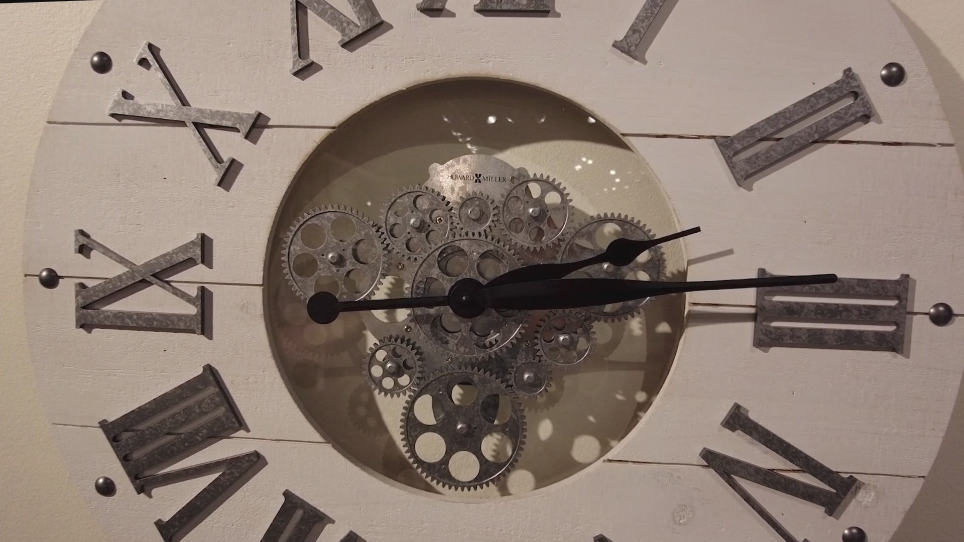 A vintage clock with Roman numerals and visible gears in the center.