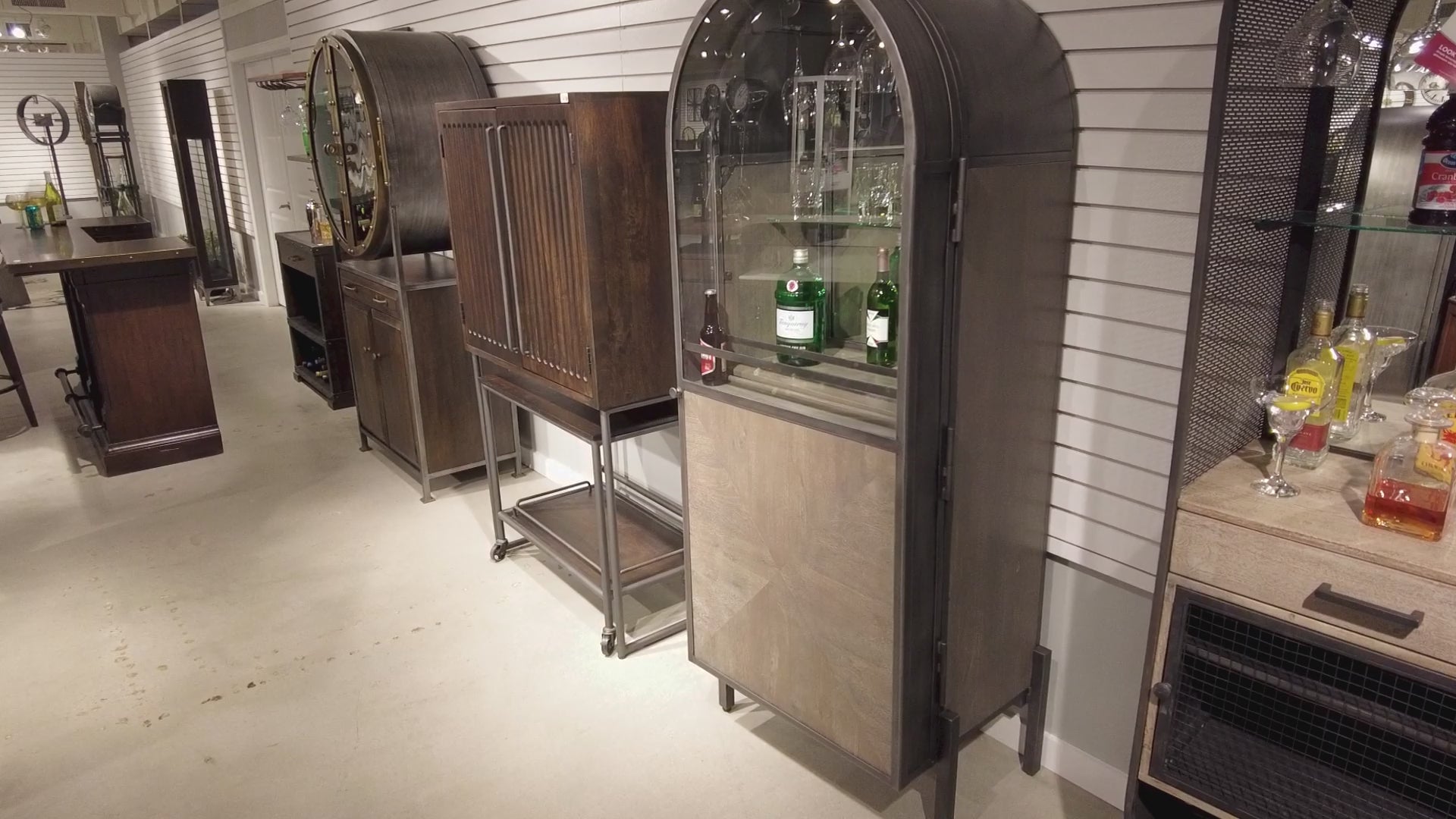 Interior display of modern bar cabinets in a retail setting.