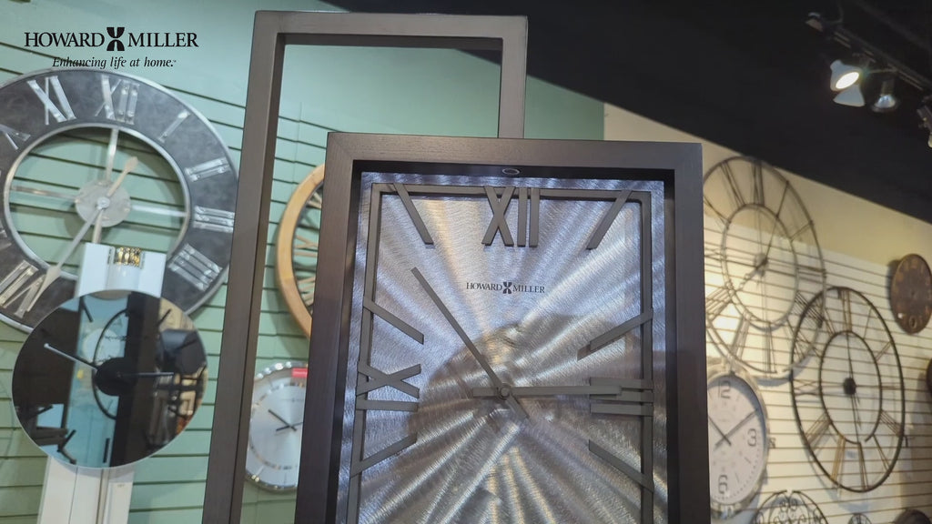 Close-up of modern wall clocks displayed in a store interior.