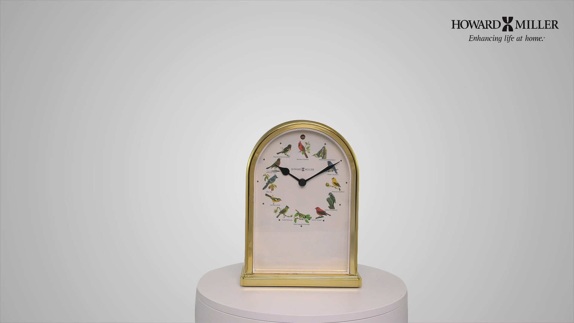 A decorative tabletop clock with an arched design and floral accents.
