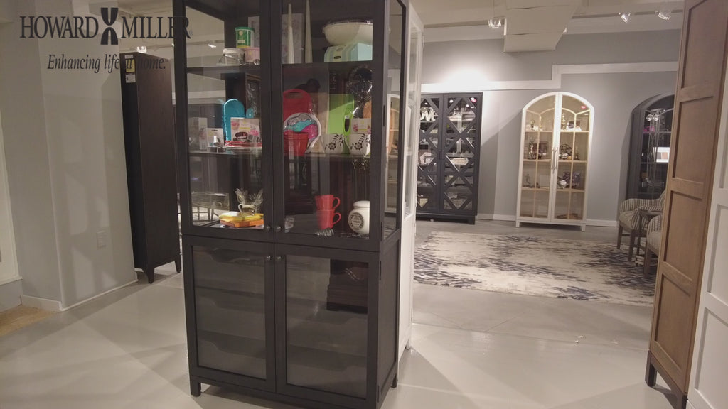 Interior display featuring a glass cabinet showcasing various items, set in a modern showroom.