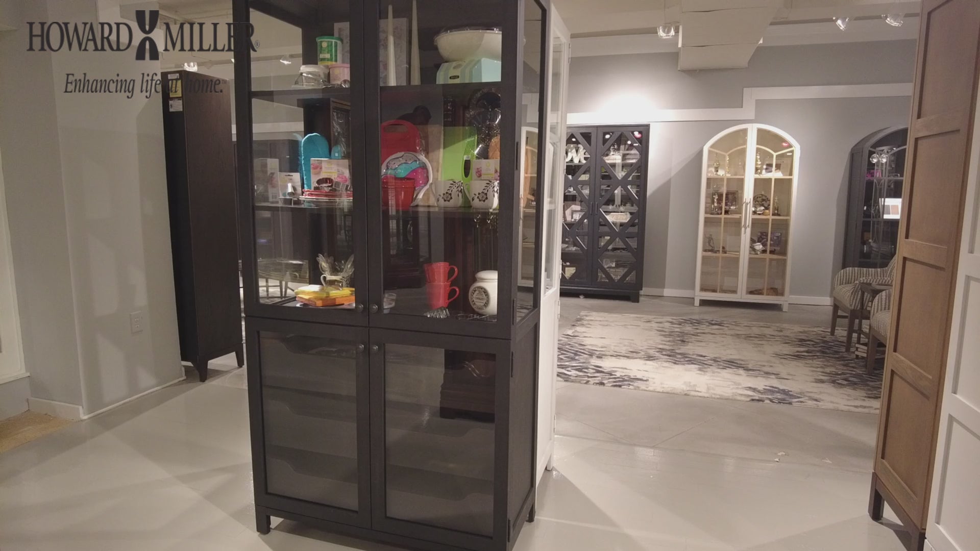 Interior display featuring a glass cabinet showcasing various items, set in a modern showroom.