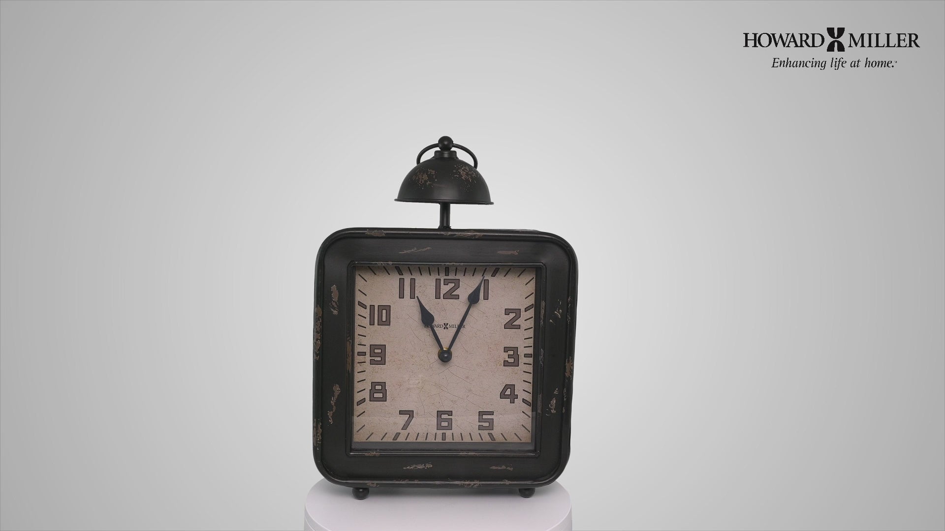 Vintage black alarm clock with white face and bell on top