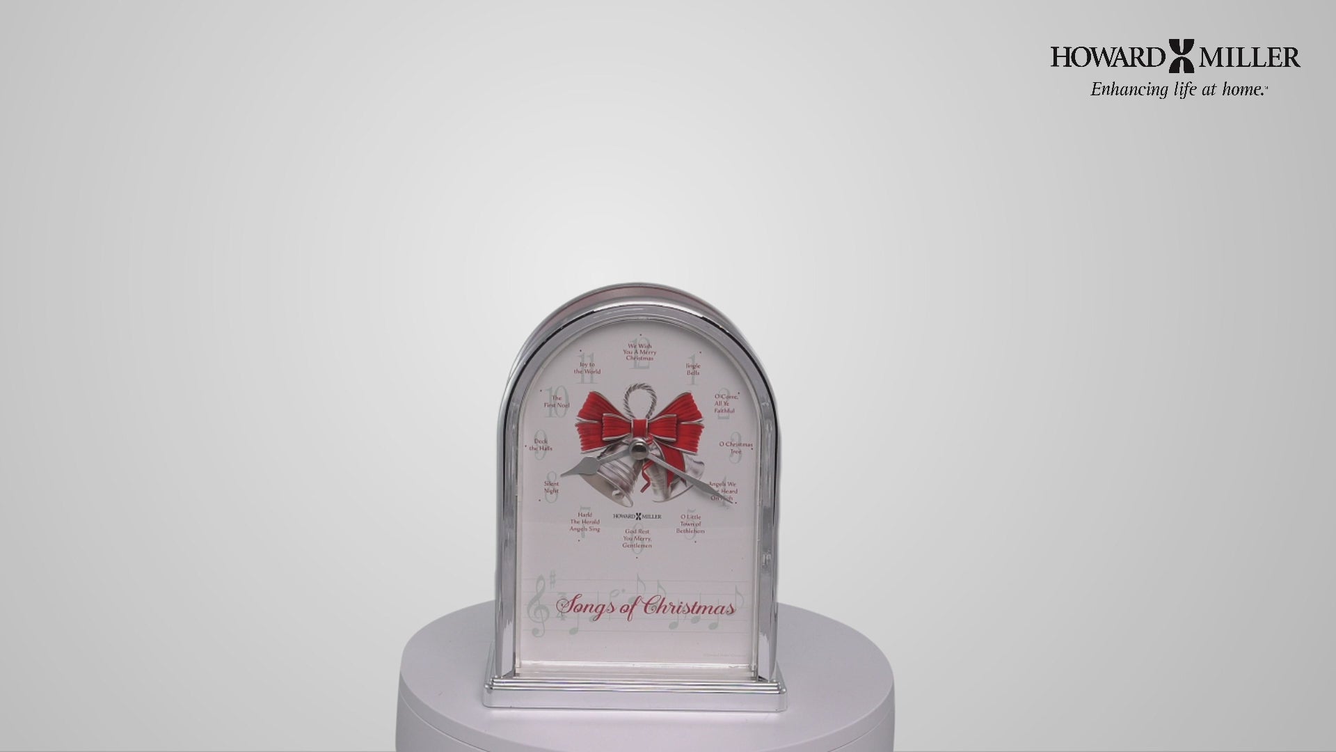 A decorative clock with a red bow and festive design.