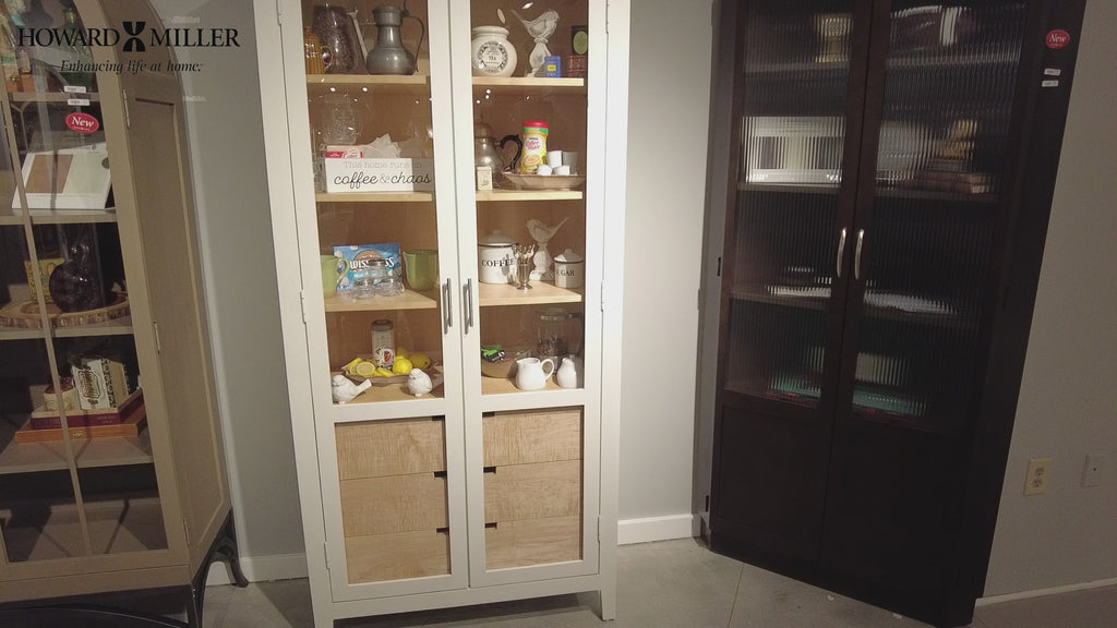 Display cabinets with various decorative items and tableware.