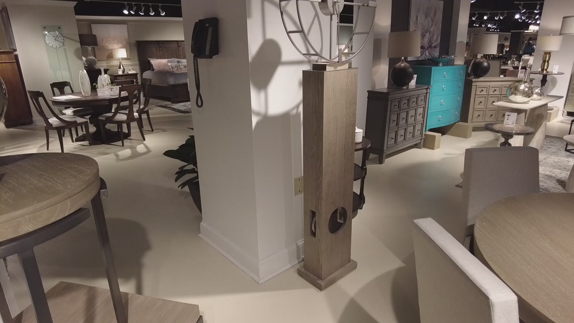 Interior view of a furniture showroom featuring various tables and decorative pieces.