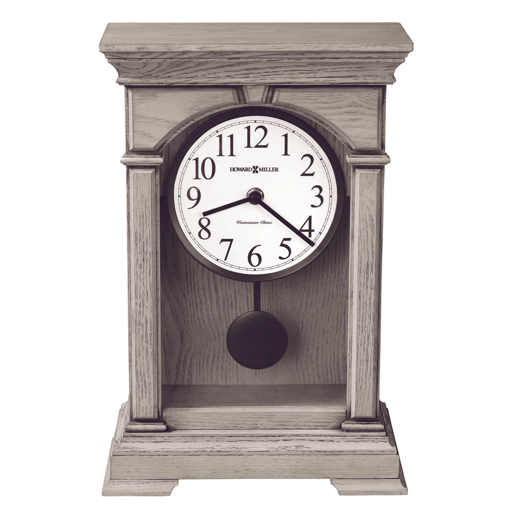 A vintage wooden mantel clock with a white clock face displaying black numbers.
