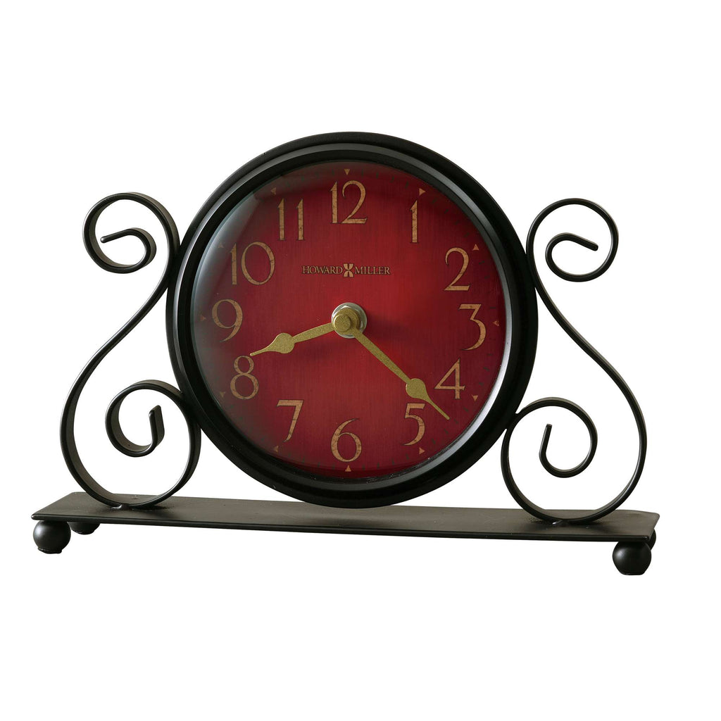A vintage-style clock with a red face and ornate black stand.