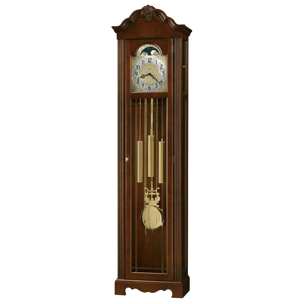 Tall wooden grandfather clock with a pendulum and decorative face.