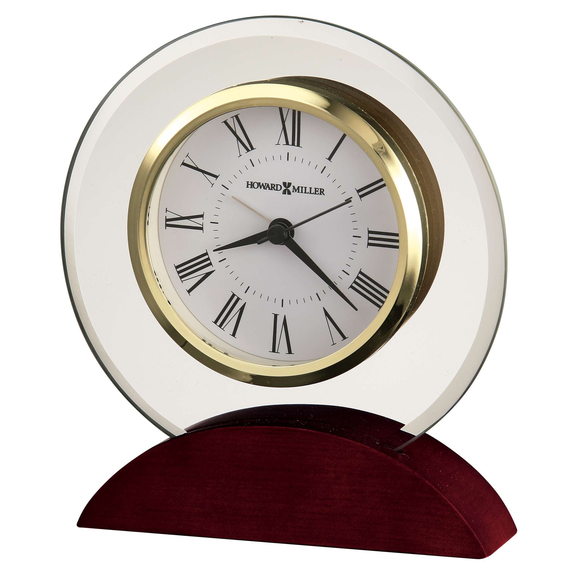 A decorative tabletop clock with a round glass face, gold accents, and a wooden base.