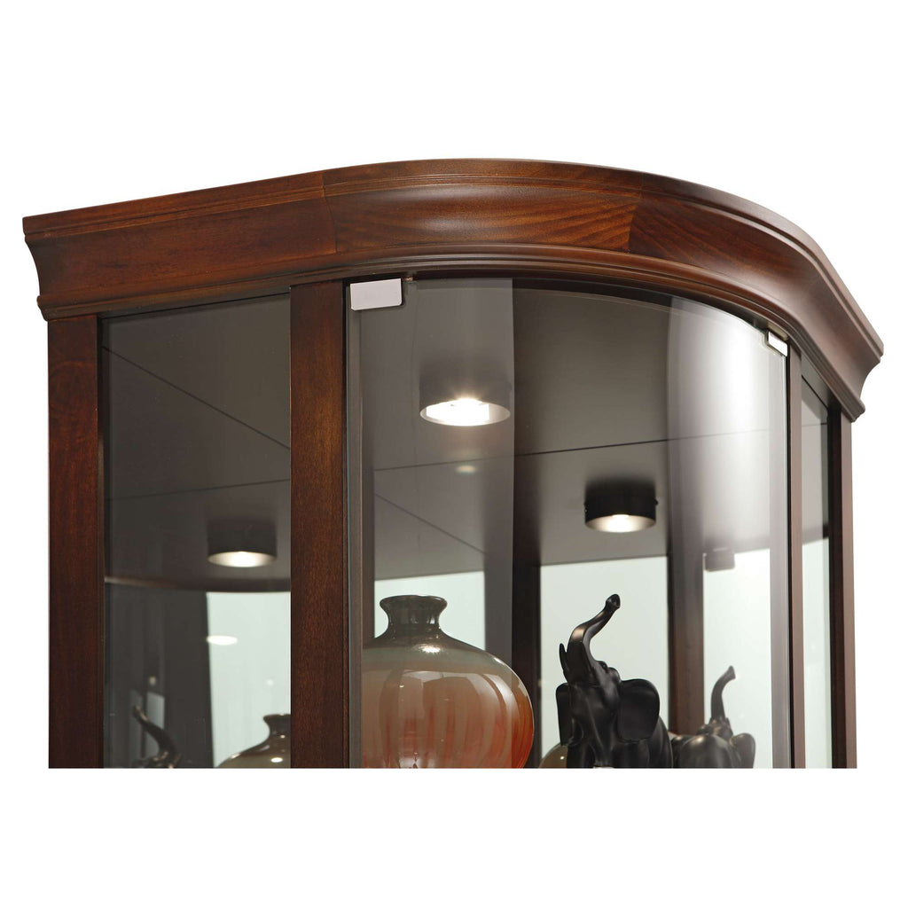 Wooden display cabinet with glass doors showcasing decorative items.