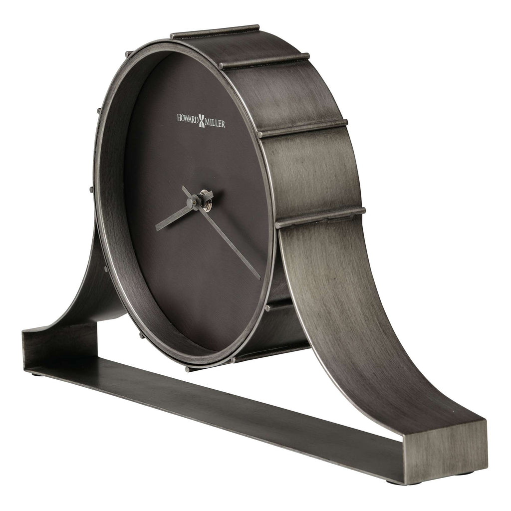 A stylish metal desk clock with a unique curved base and a dark dial.
