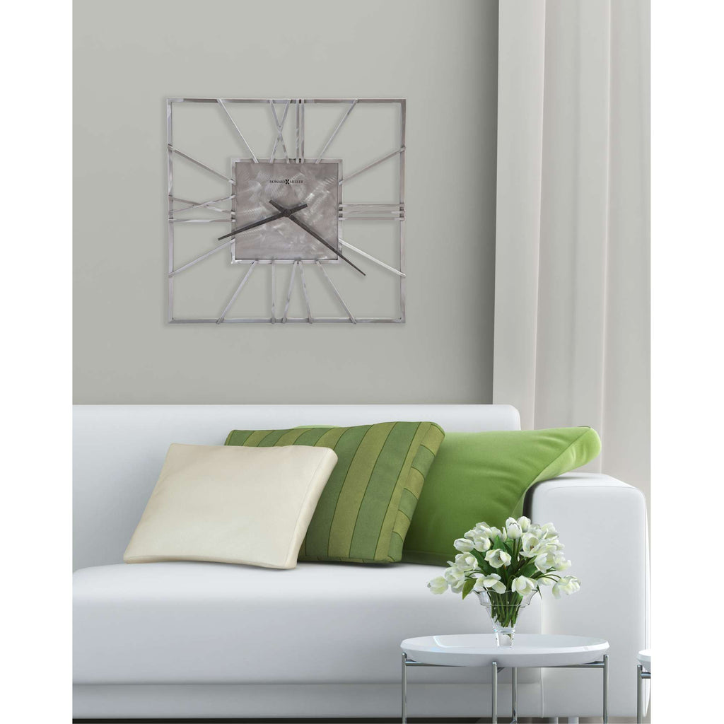 A modern living room setup featuring a white sofa with decorative pillows and a clock on the wall.