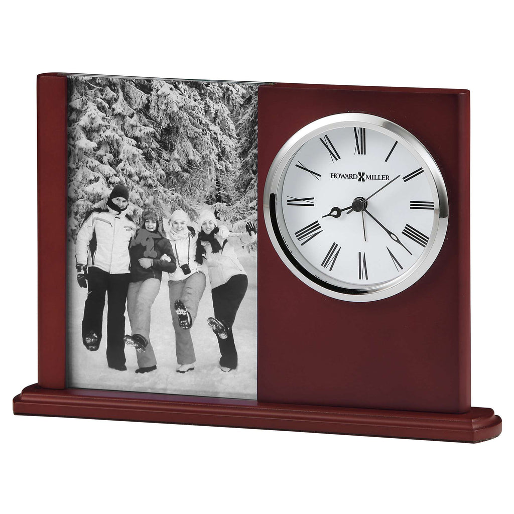 A decorative clock with a photo slot, displaying a black and white image of three people outdoors in a snowy setting.