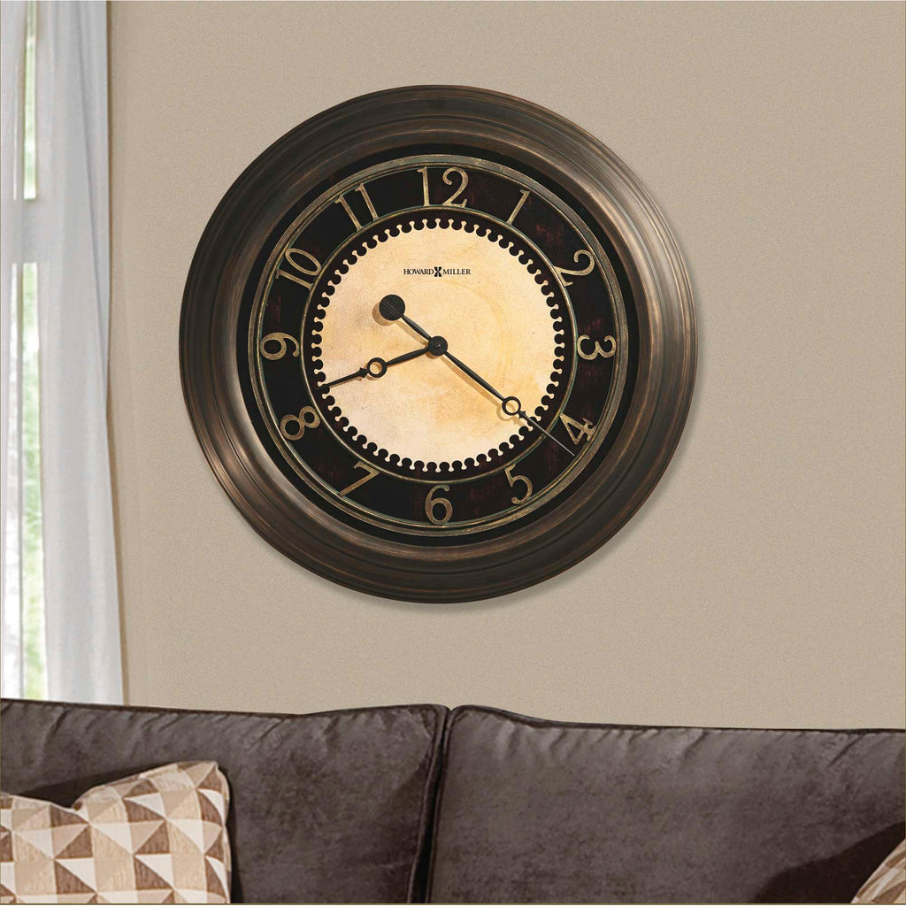 Wall clock with black frame and cream-colored face hanging above a couch.