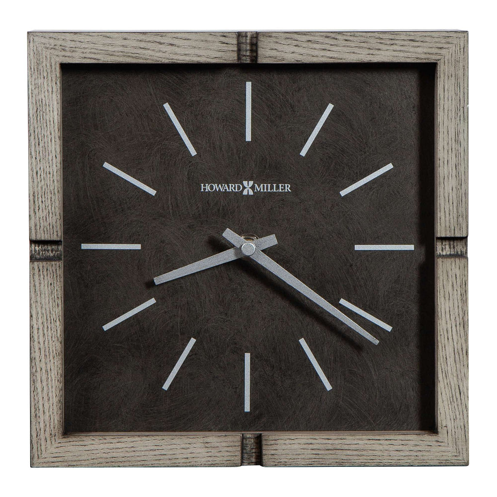 Square wall clock with minimalist design and silver hands on a dark background.