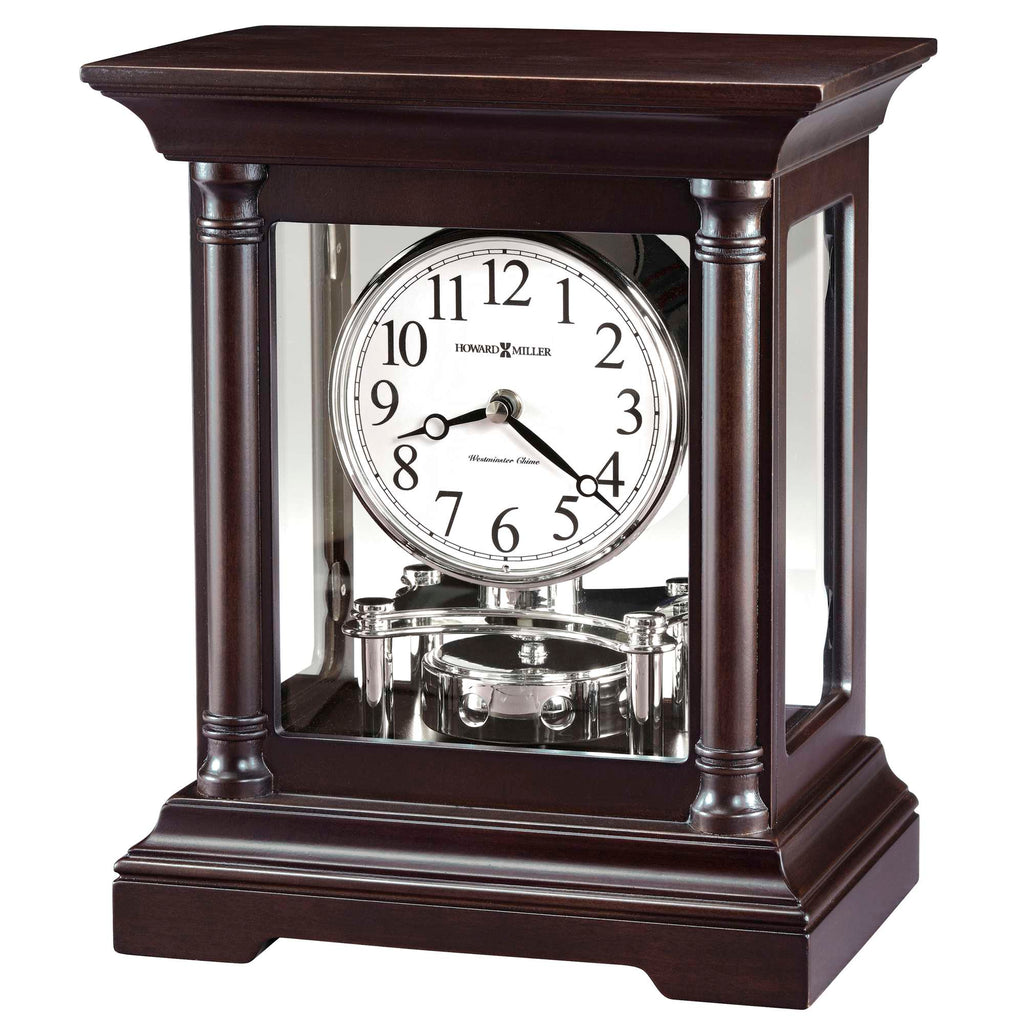 A classic wooden mantel clock with a glass front and roman numerals.