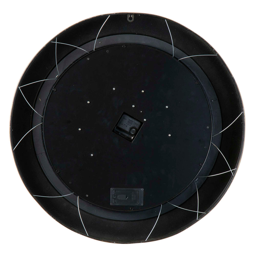 Bottom view of a round black object with a central square component and white wiring.