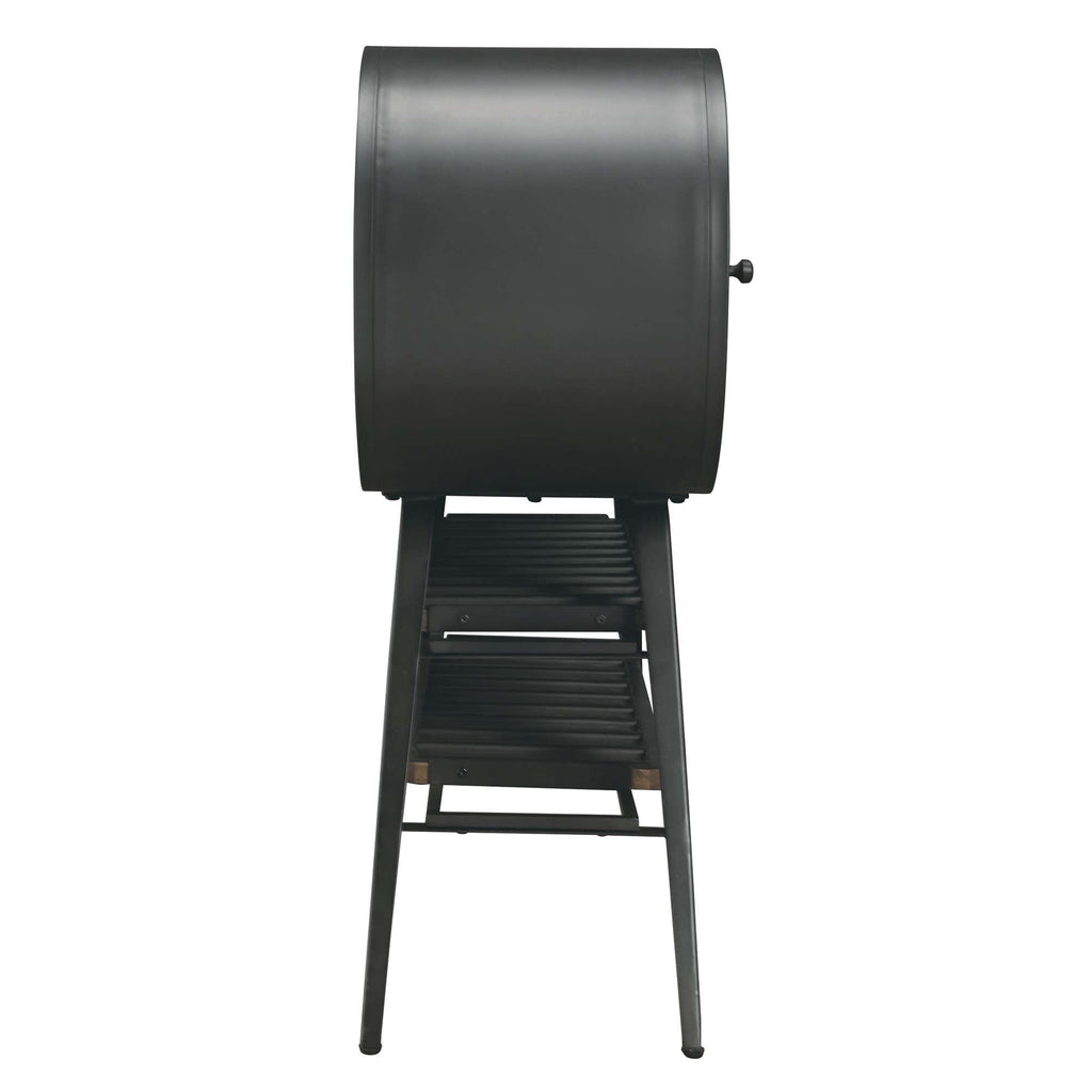 Side view of a black drum-style grill on a stand.