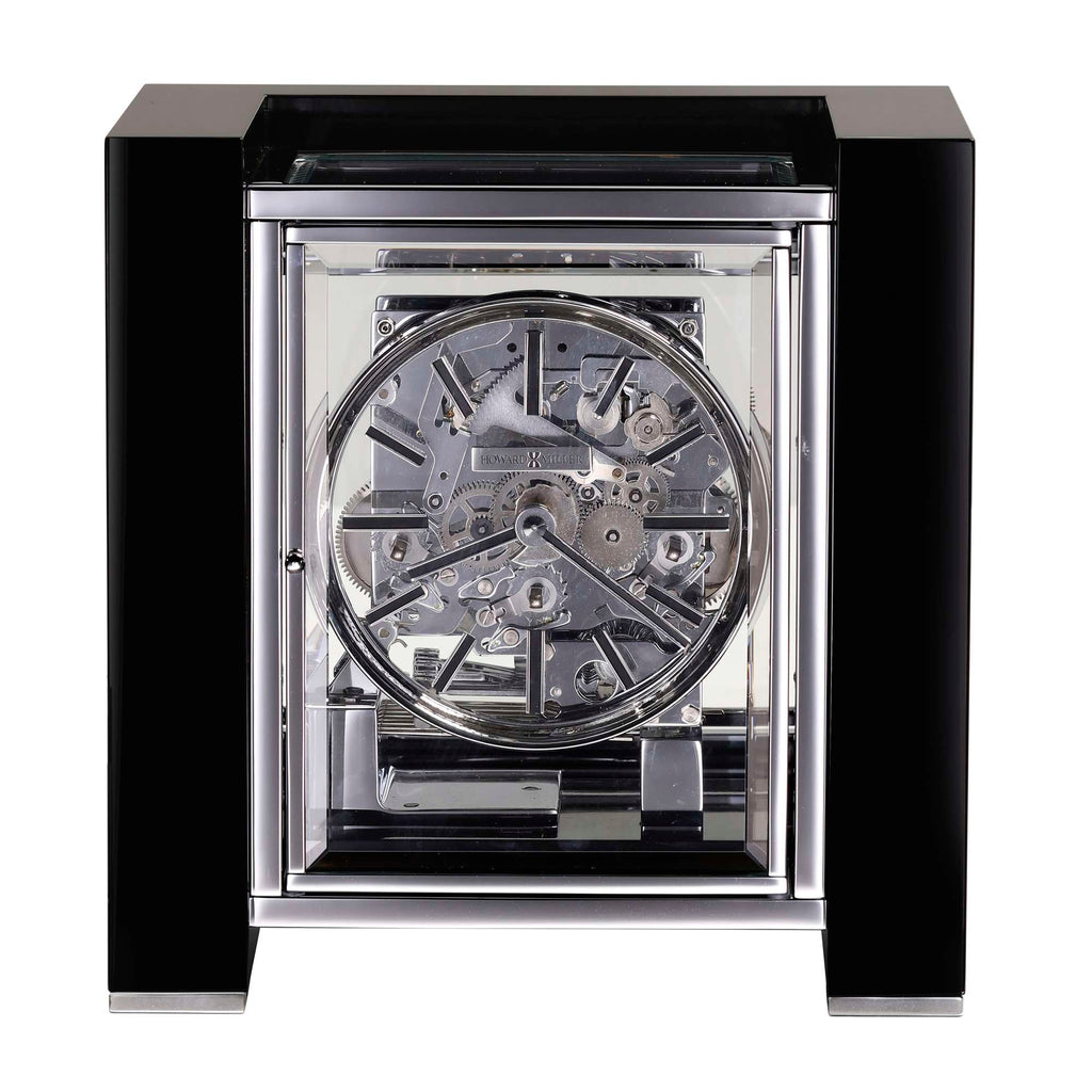 Close-up of a transparent mechanical clock with a black frame.