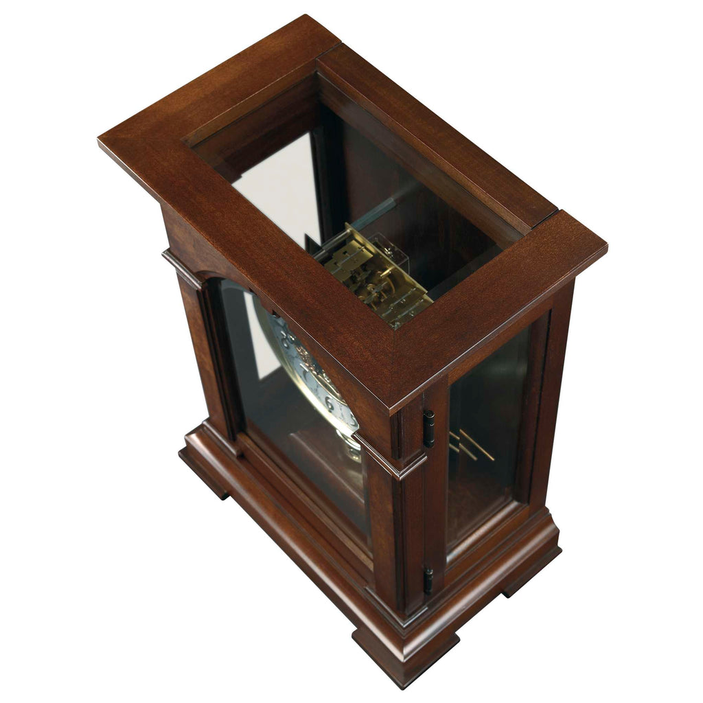 A wooden display cabinet with glass sides showcasing a decorative item inside.