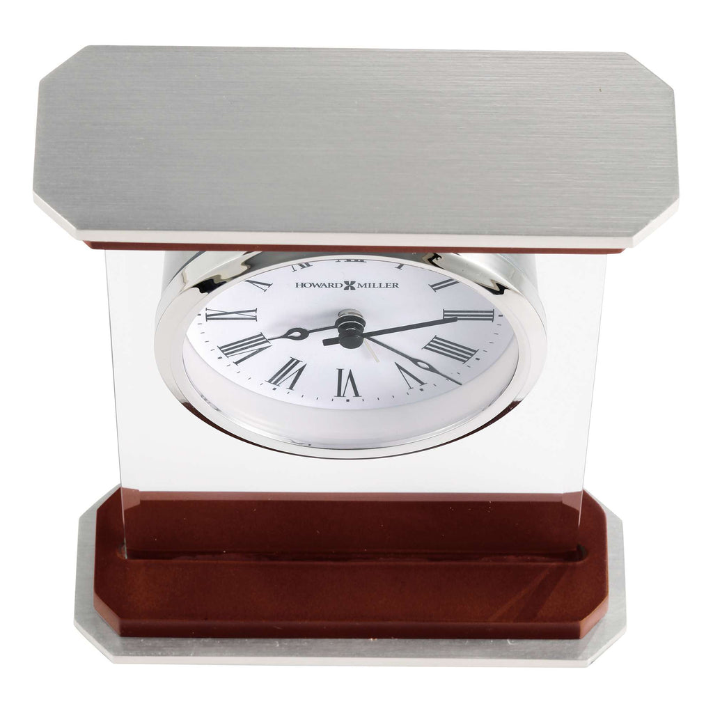 A stylish desk clock with a metallic frame and a white face featuring Roman numerals.