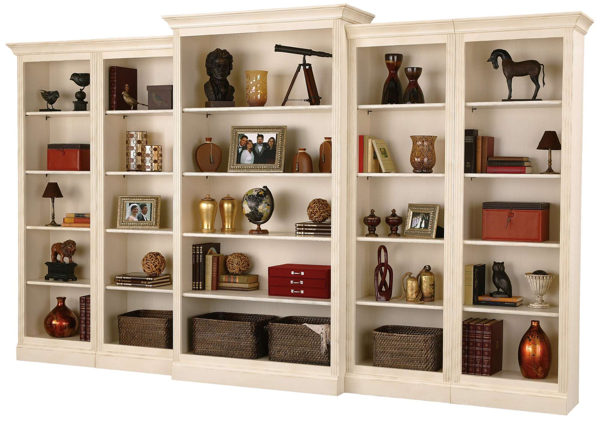 A stylish white bookshelf with various decorative items, books, and photo frames arranged on its shelves.