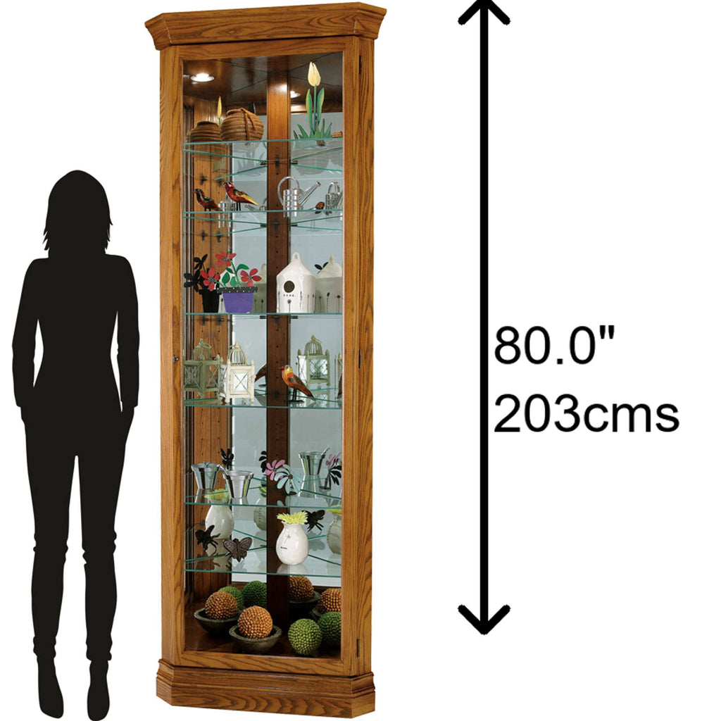 Tall wooden display cabinet with glass shelves, showcasing decorative items, alongside a silhouette of a person for scale.