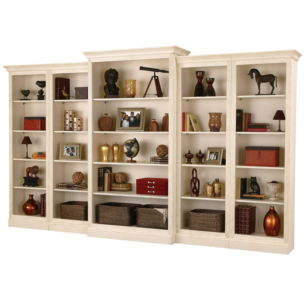 A stylish white bookshelf with various decorative items and books displayed on its shelves.