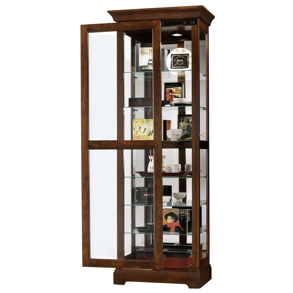 A wooden display cabinet with glass doors showcasing various collectibles and decorative items.