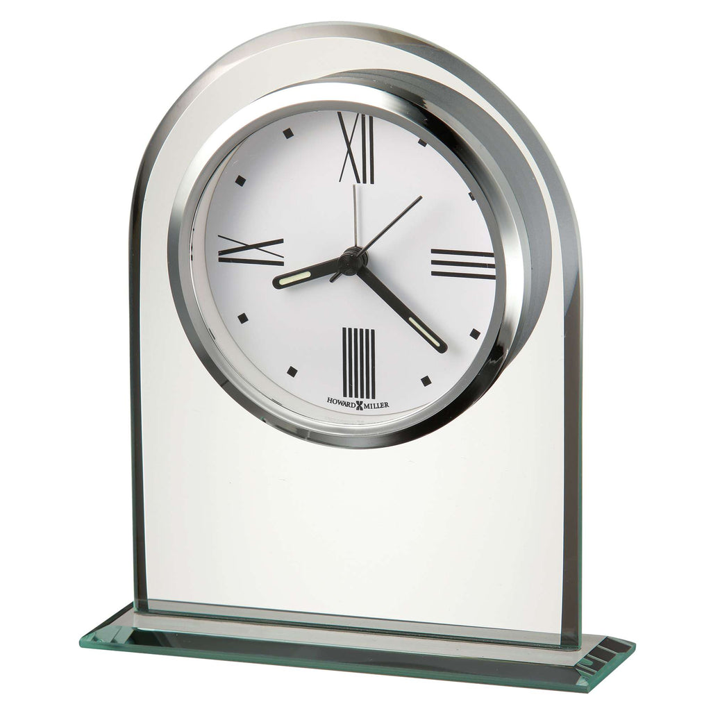 A modern, stylish tabletop clock with a glass base and a white roman numeral face.