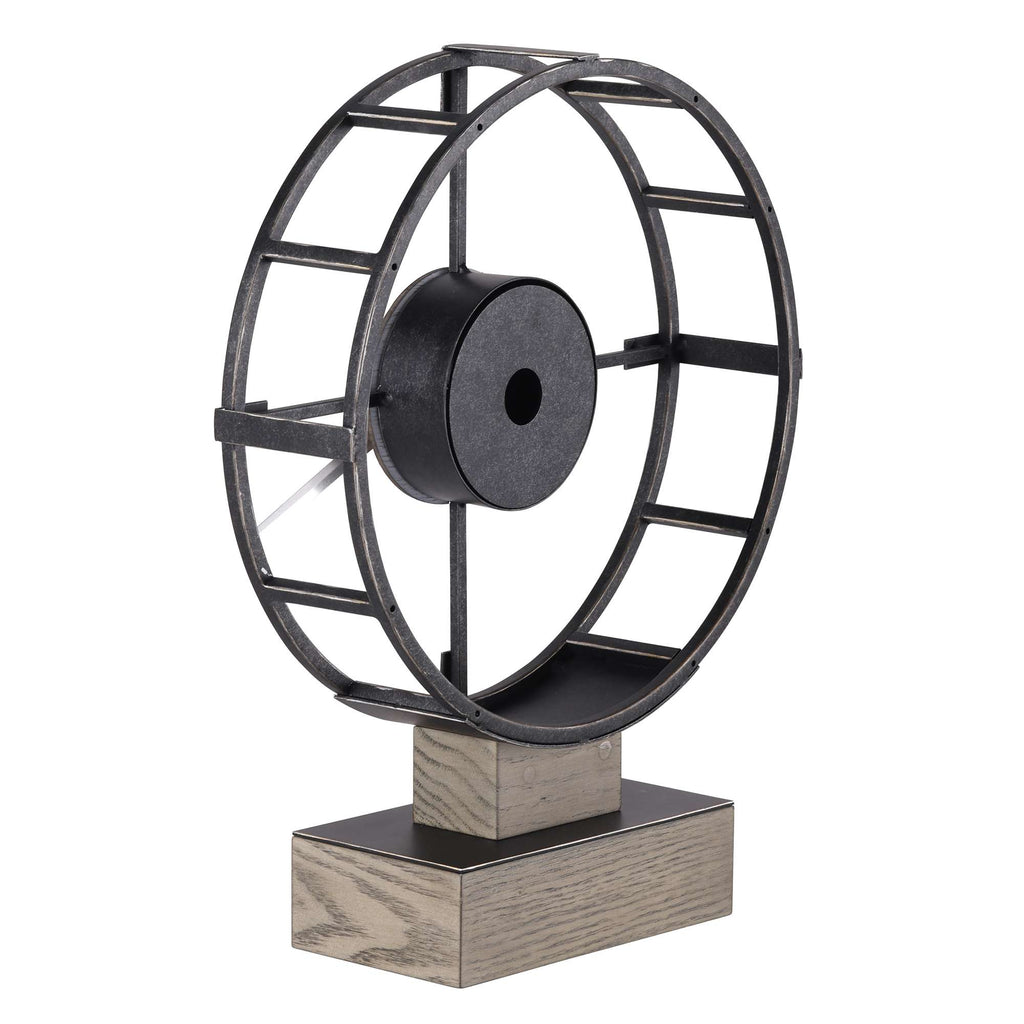 A decorative metal fan sculpture on a wooden base